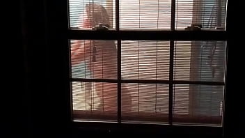 Voyeur catches sexy neighbor through window blinds